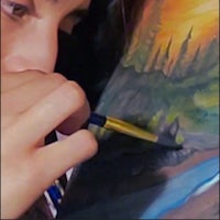 a woman is painting a painting on her chest